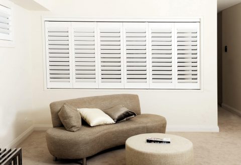 Row of white shutters in living room